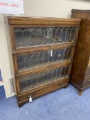 A Globe Wernicke oak three section leaded bookcase, length 85cm, depth 24cm, height 110cm