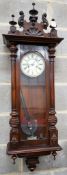 A Vienna style wall clock, having enamelled Roman dial and striking movement in glazed mahogany