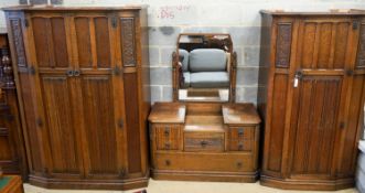 An early 20th century Jacobean revival linenfold moulded oak three piece bedroom suite, larger