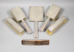 A George VI engine turned silver mounted Art Deco five piece mirror and brush set, S.J. Rose &