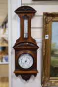 J Brown, Glasgow, a late Victorian carved walnut cased aneroid barometer and thermometer, height