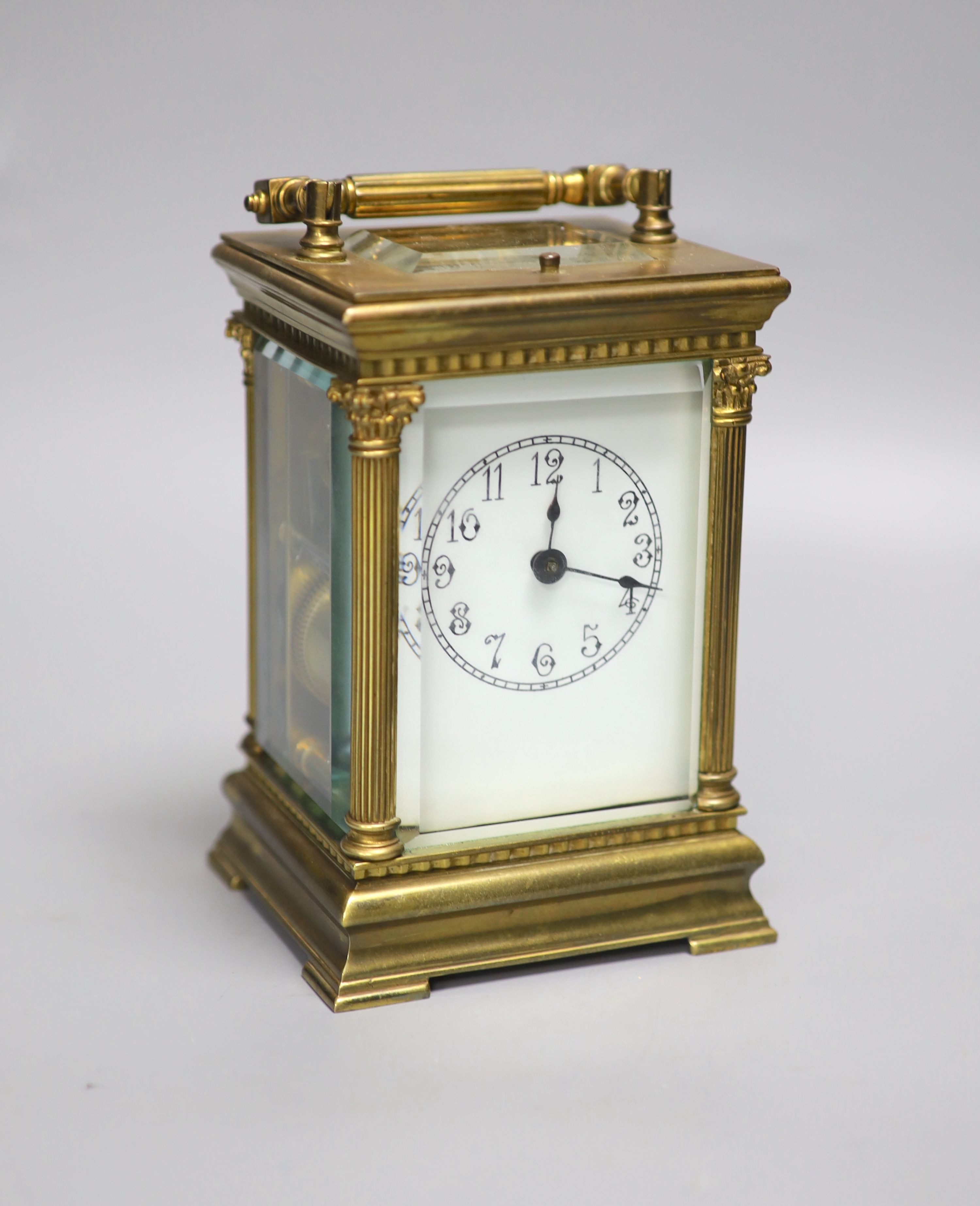 An Edwardian Corinthian brass repeating carriage clock, 20cm high to handle