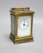 An Edwardian Corinthian brass repeating carriage clock, 20cm high to handle