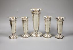 A set of four George V silver posy vases, 11.5cm high, together with a single tall example, 16cm