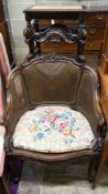 A French style carved walnut frame bergere with caned panels on cabriole legs, length 70cm, depth