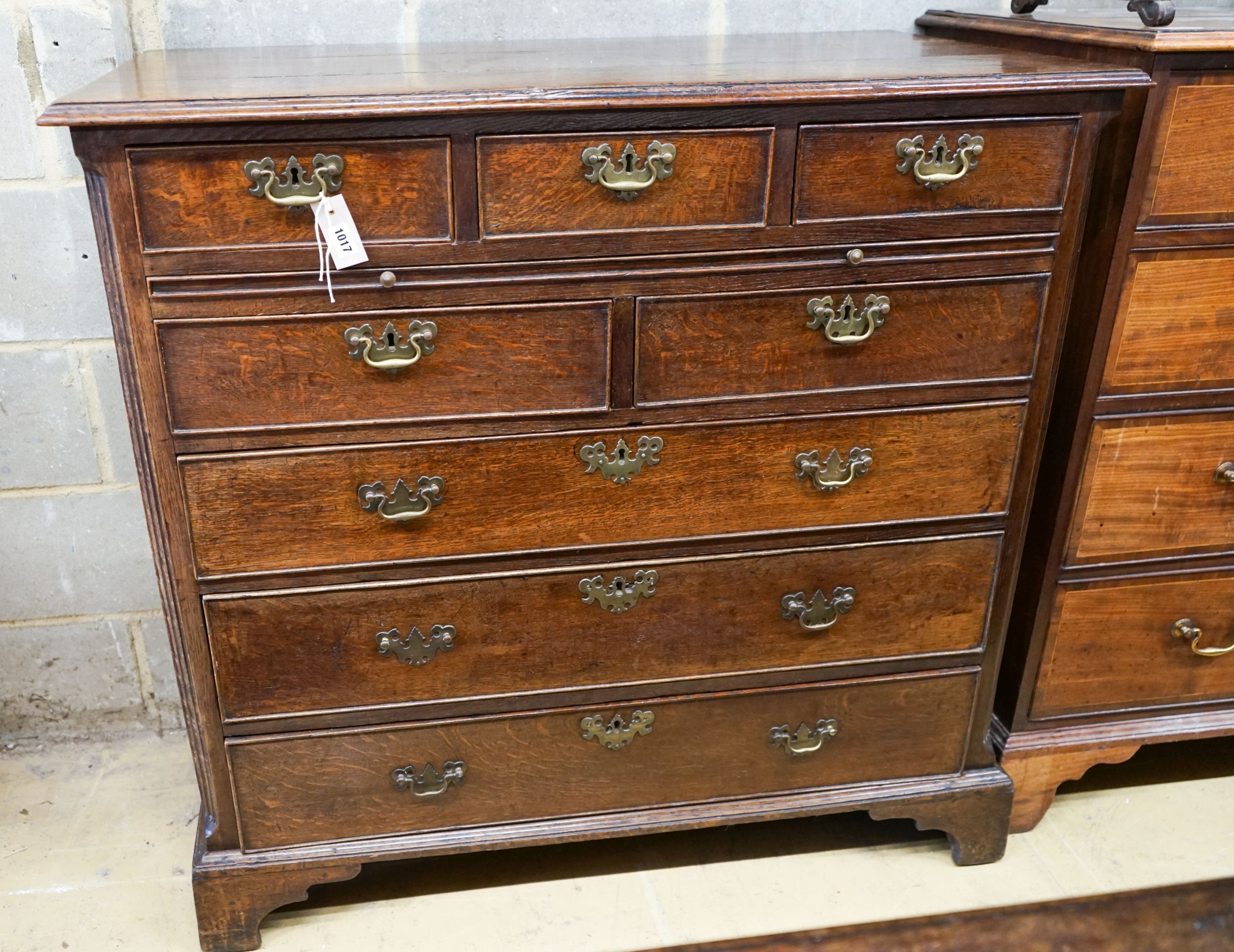 A George III oak chest,fitted five short drawers and three long drawers with brass swan-neck
