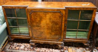 A Queen Anne revival figured walnut breakfront bookcase,fitted astragal-glazed door on short claw