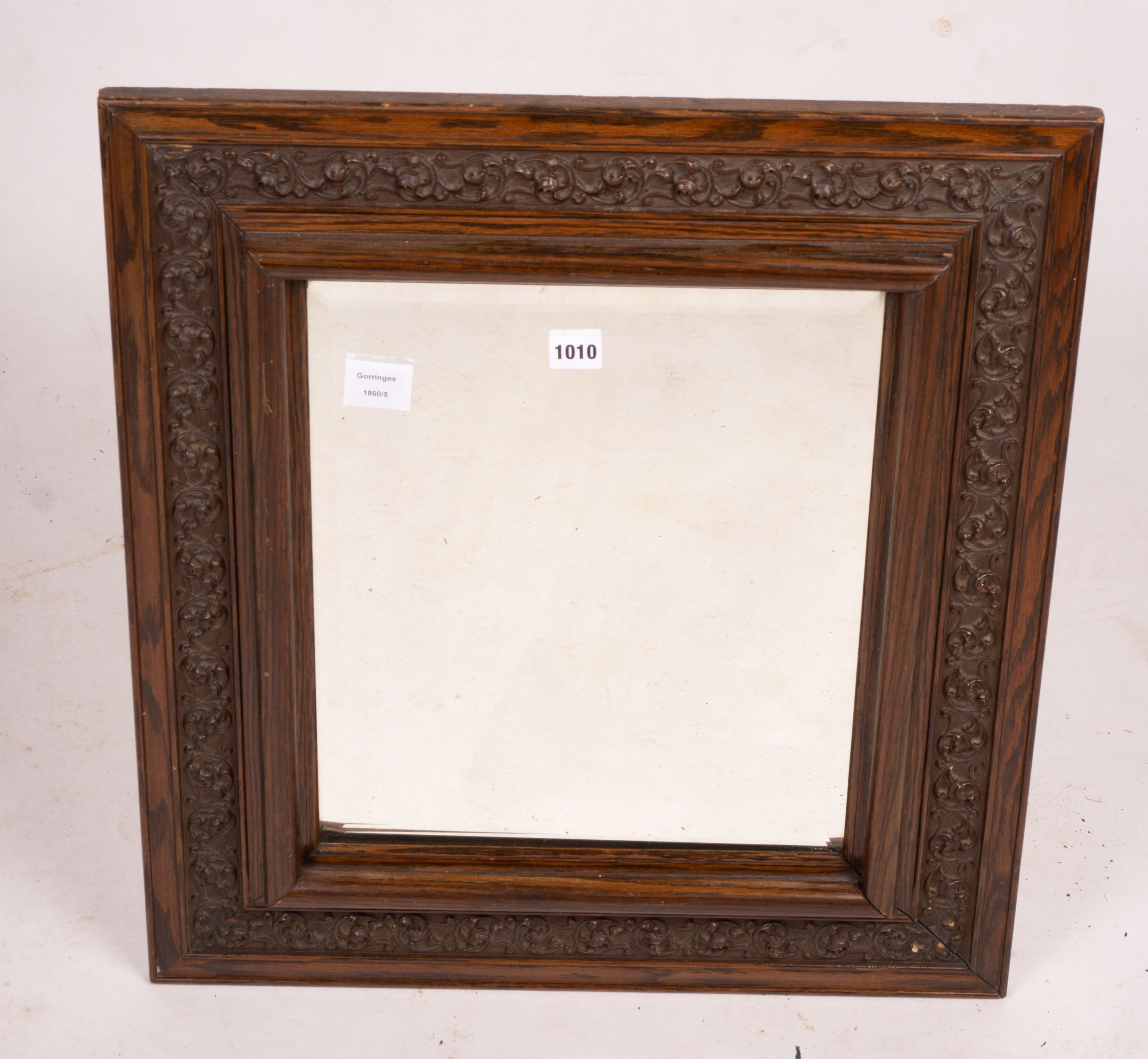 An early 20th century carved oak rectangular wall mirror, width 57cm, height 64cm