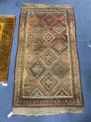 A North West Persian geometric polychrome brick red ground rug, 184 x 96cm