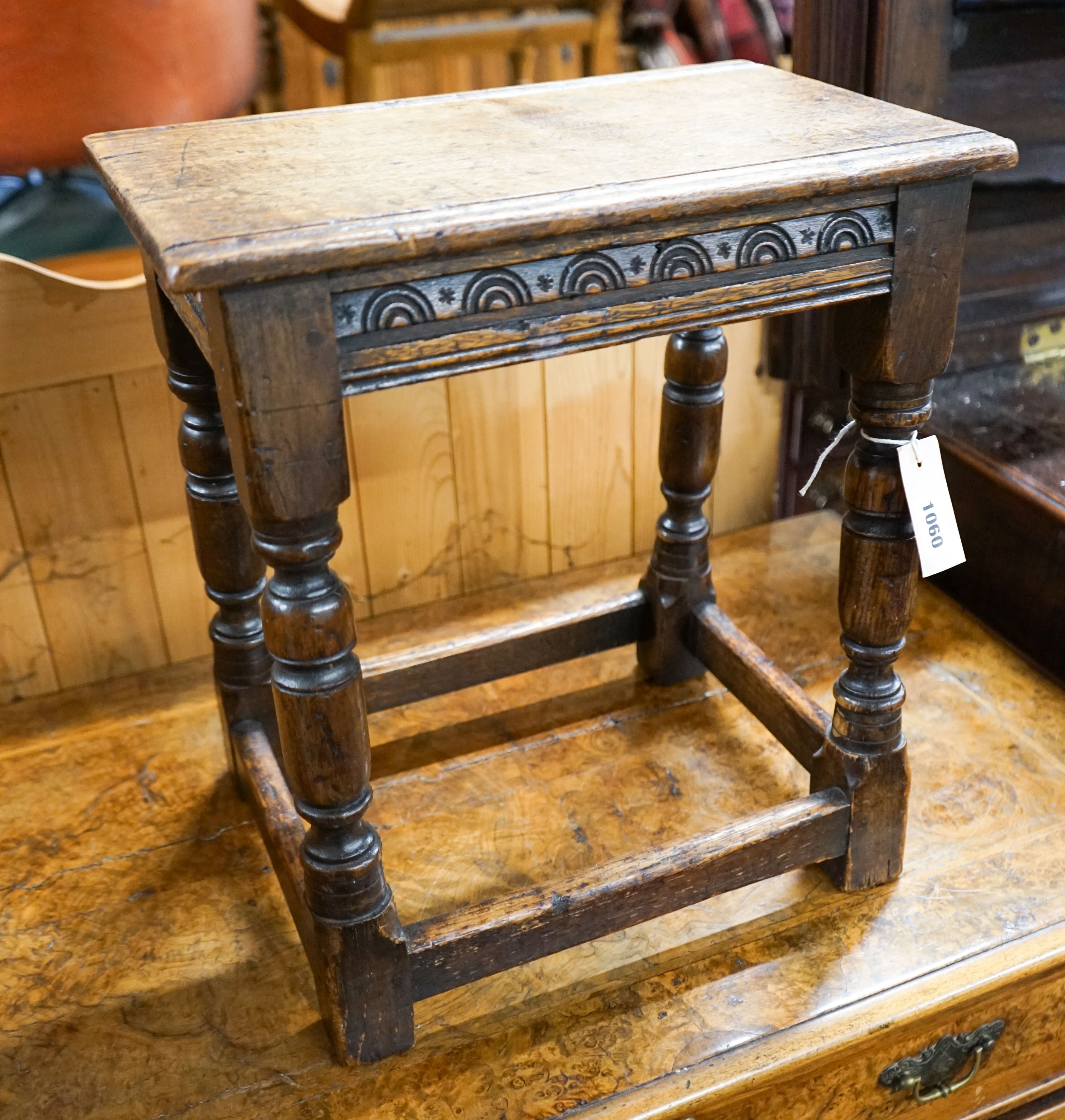 An 17th century style carved oak joint stool on turned supports, length 40cm, depth 25cm, height