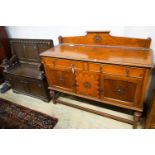 An 18th century style oak monks bench together with a 1920's oak sideboard