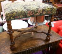 A William and Mary style walnut stool, having embroidery-covered seat on turned supports with