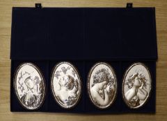 A cased set of four modern Italian repousse 850 white metal mounted 'The Four Seasons' wall plaques,