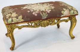 A Louis XV style carved giltwood dressing stool, with a pierced apron, on short cabriole legs,