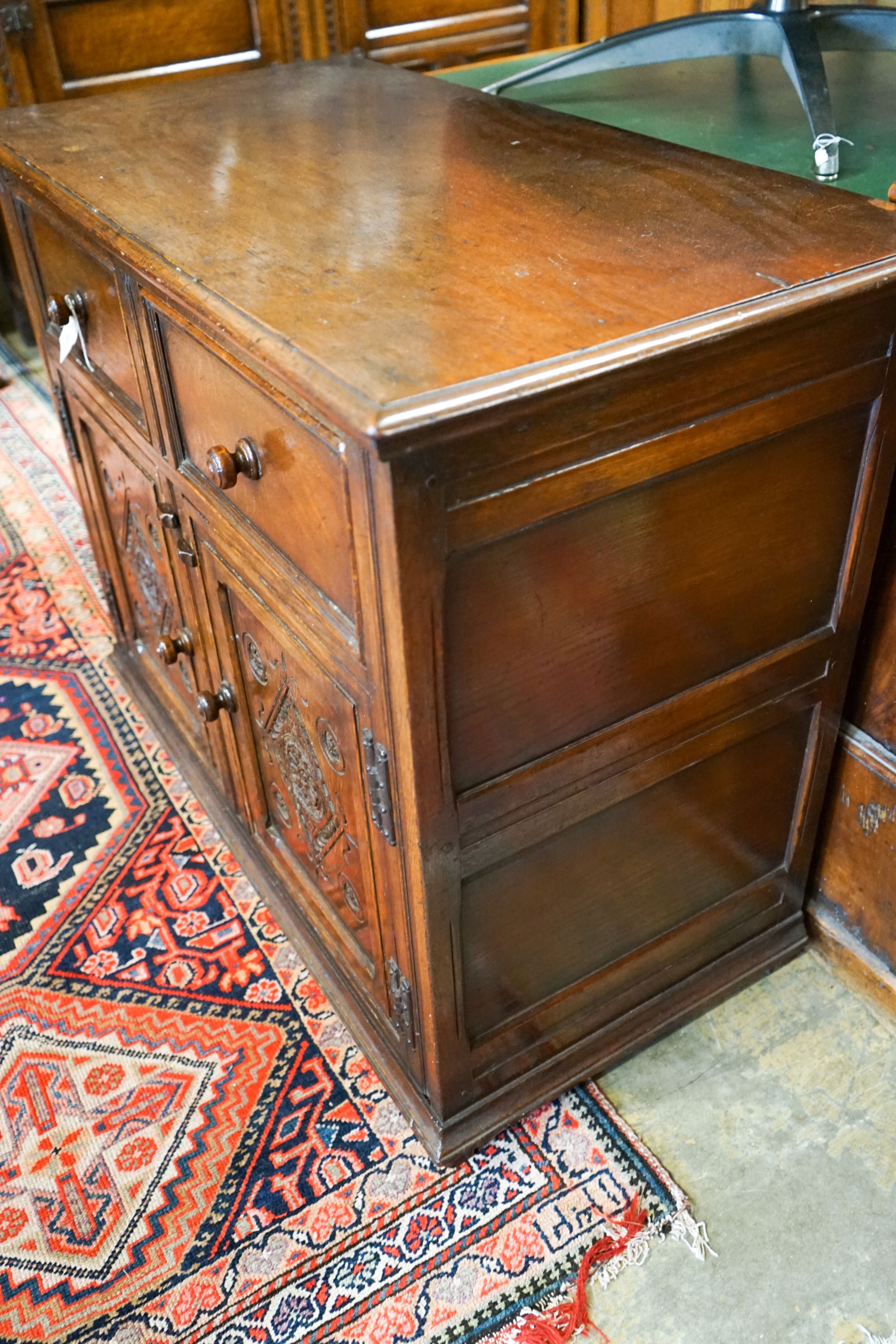 A 17th century style carved and panelled oak cupboard,fitted two drawers and two cupboards, width - Image 4 of 4