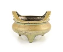 A large Chinese bronze tripod censer, ding, Xuande mark, Qing dynasty,the rim with a pair of high