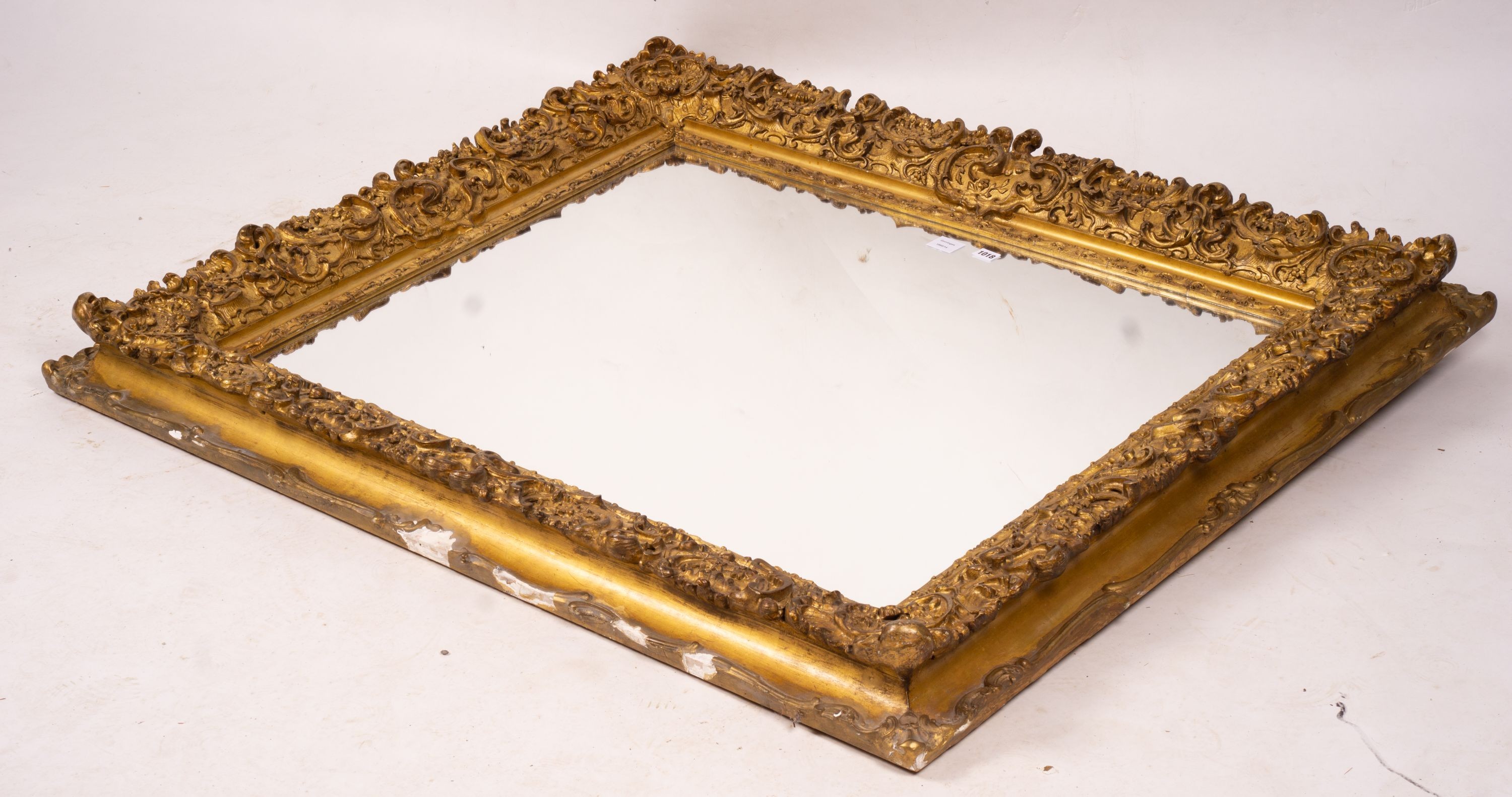 An ornate Victorian giltwood and gesso rectangular wall mirror (formerly a picture frame) width