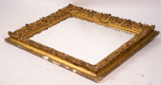 An ornate Victorian giltwood and gesso rectangular wall mirror (formerly a picture frame) width
