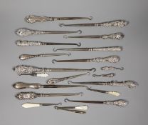 A collection of assorted silver handle button hooks and a nail implement.