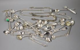 A quantity of assorted silver flatware including Georgian and later sugar tongs, condiment spoons