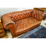 A late Victorian drop arm leather button back Chesterfield settee, length 170cm, depth 88cm,