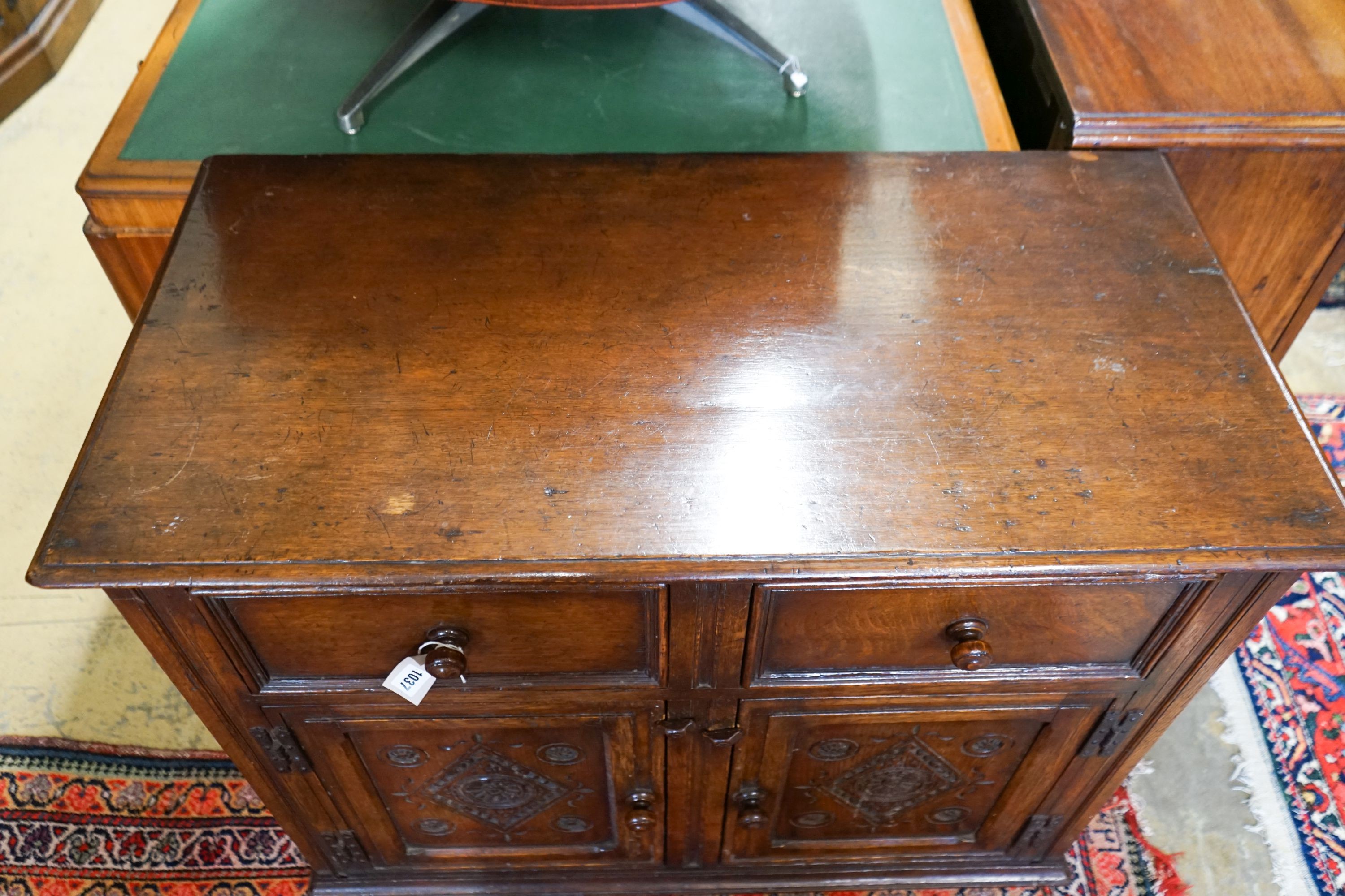 A 17th century style carved and panelled oak cupboard,fitted two drawers and two cupboards, width - Image 2 of 4