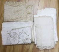 A collection of crochet edged linen tablecloths, a filet cloth and a 225cm long ornately cutworked
