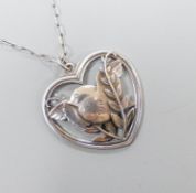 A Georg Jensen sterling 'Robin and frond' heart shaped pendant, no. 97, 38mm, on a white metal