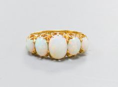 An Edwardian 18ct gold and graduated five stone white opal set half hoop ring, size K, gross 3.8