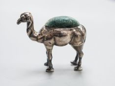 A George V novelty silver mounted pin cushion, modelled as a camel, ?H &S, Birmingham, 1911,