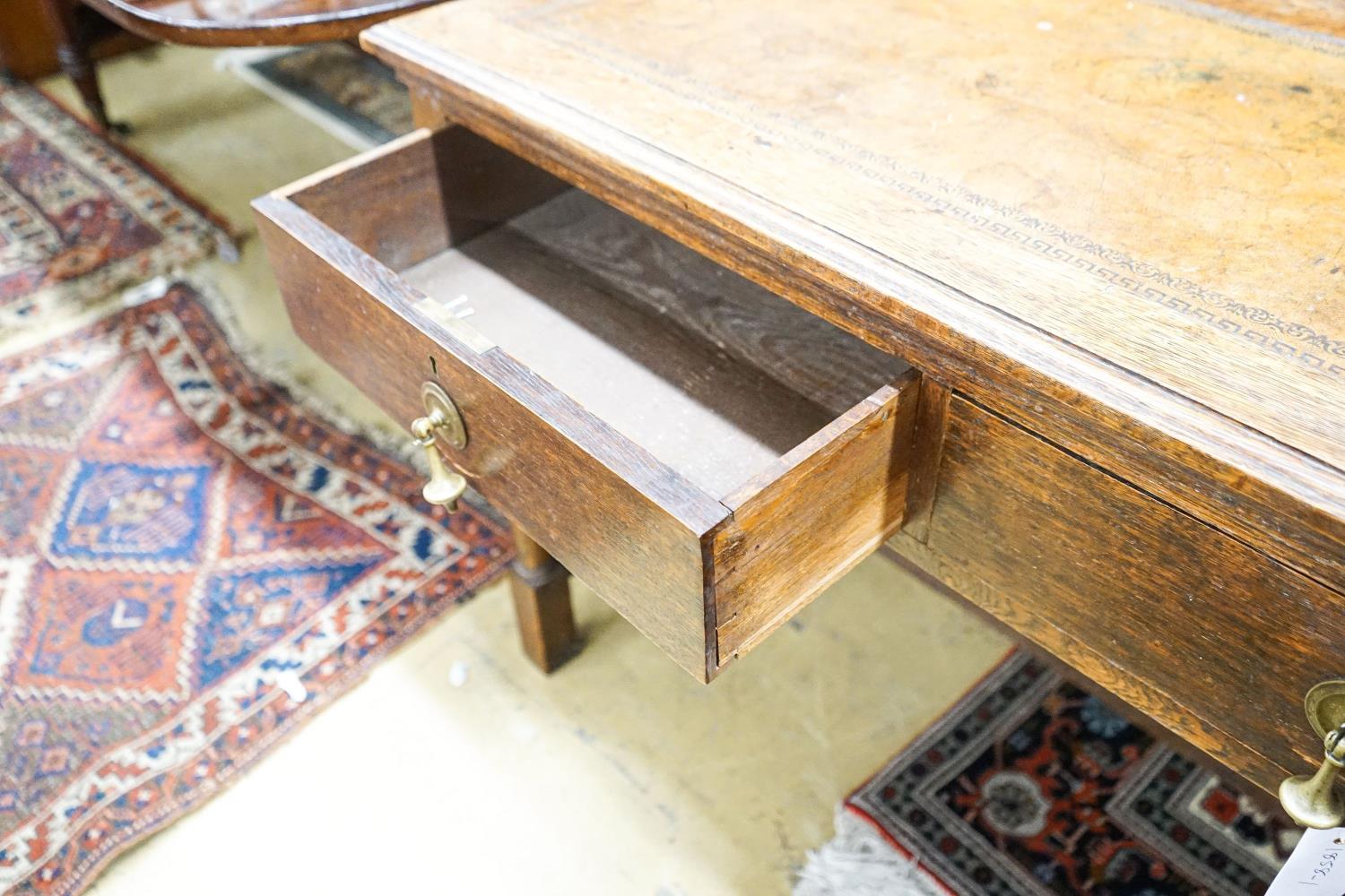 A 1920's oak two drawer writing table, with a leather inset top, length 106cm, depth 52cm, height - Image 4 of 4