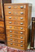 An early 20th century teak nine drawer filing chest with single locking bar, width 70cm, depth 63cm,