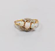 An 18ct and plat, three stone white opal and diamond chip set crossover ring, size S, gross weight