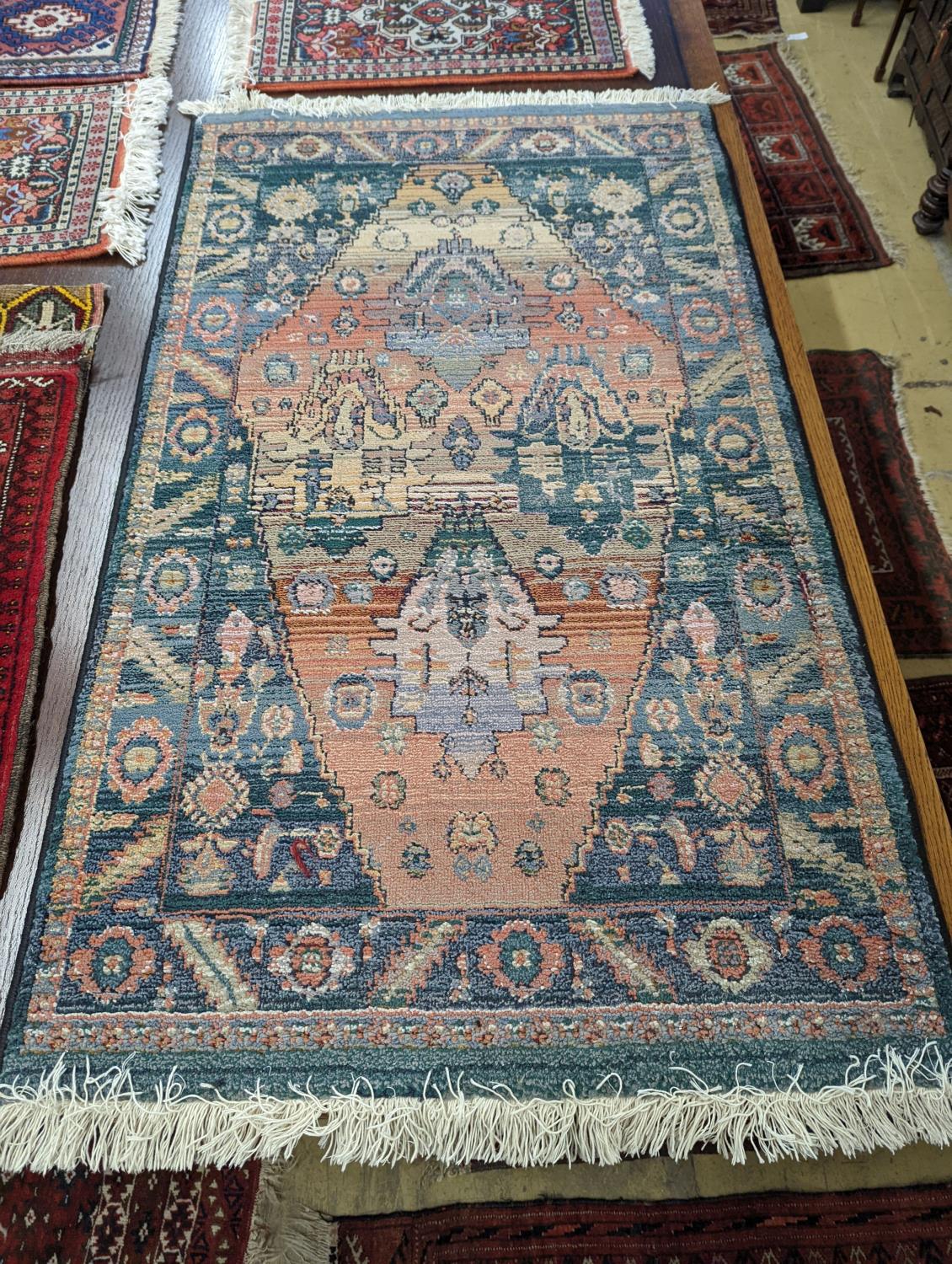 A Caucasian red ground mat, a Bokhara mat, three others and a blue ground rug, largest 136 x 80cm ( - Image 4 of 7