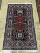 A Caucasian blue ground rug, 166 x 100cm