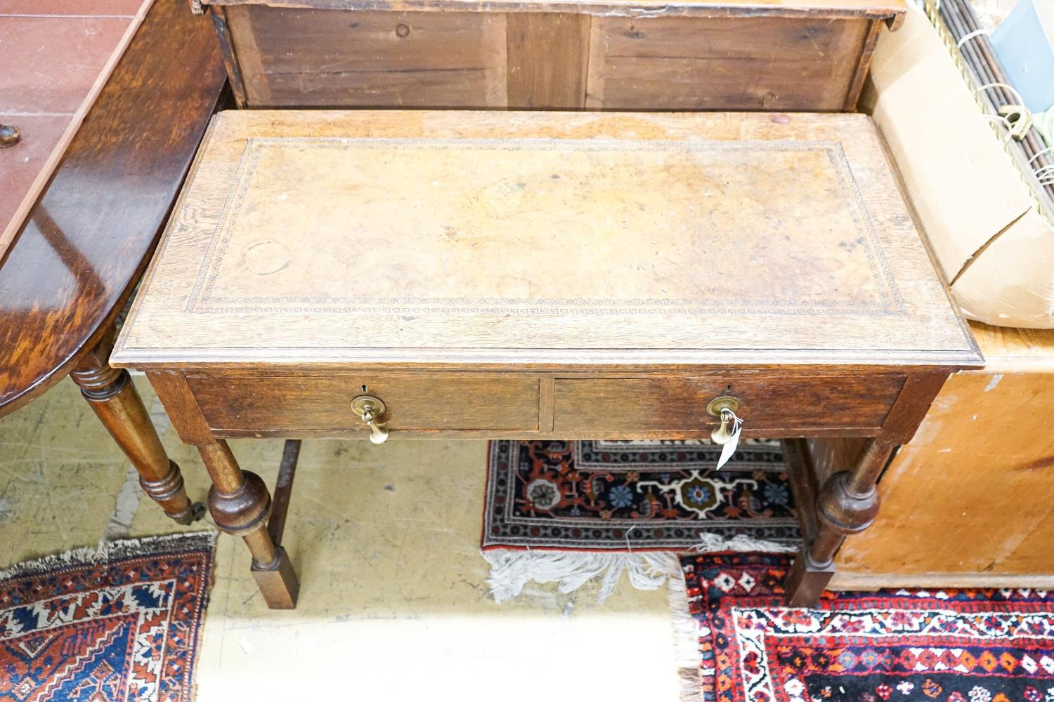 A 1920's oak two drawer writing table, with a leather inset top, length 106cm, depth 52cm, height - Image 2 of 4