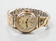 A gentleman's 9ct gold Roamer mid size manual wind wrist watch, on an associated flexible bracelet,