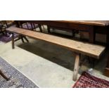 A 19th century French provincial cherry bench seat, length 242cm, depth 46cm, height 46cm