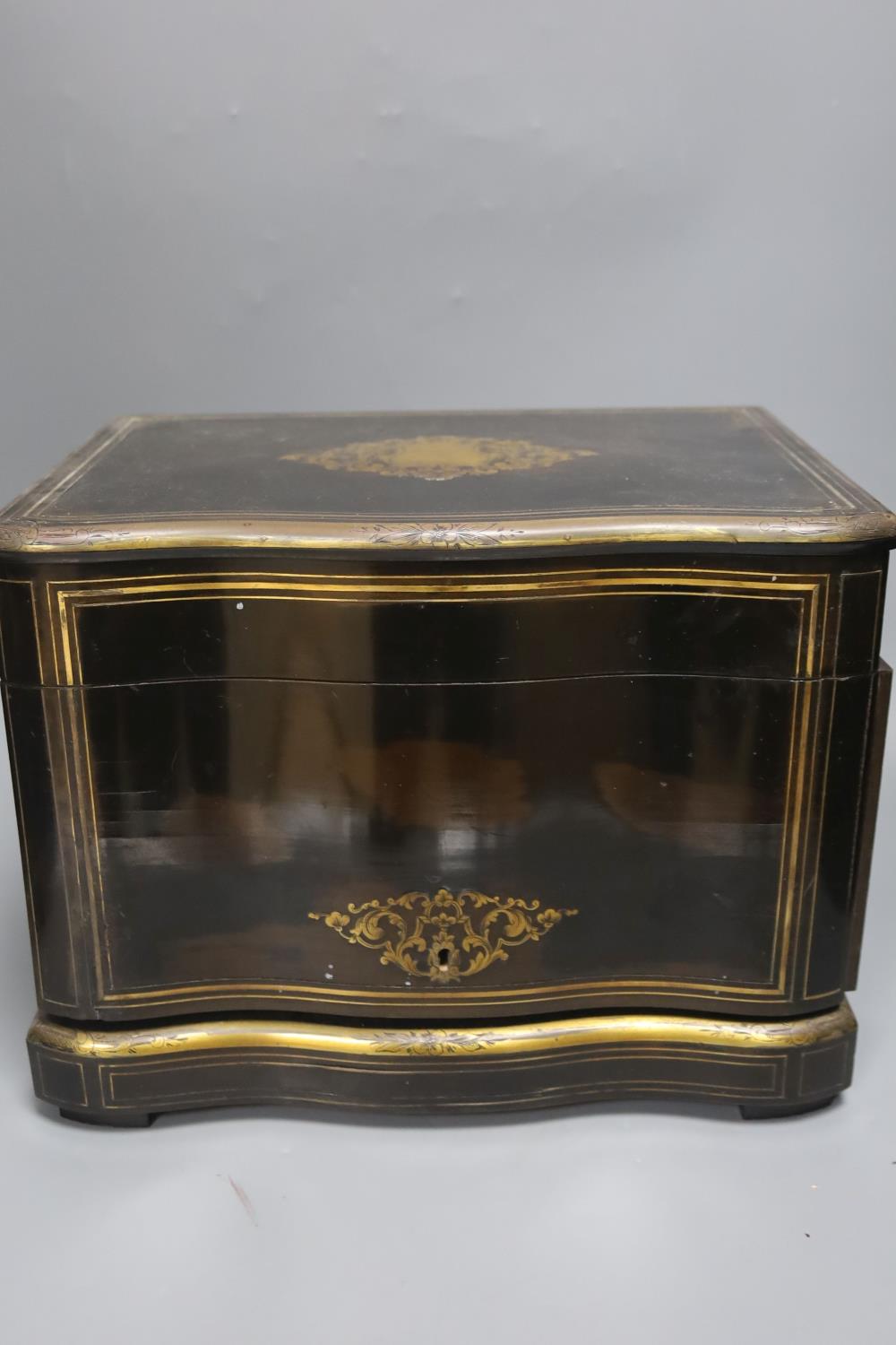 A mid-19th century French ebonised and brass-inlaid decanter case, fitted four decanters and seven - Image 4 of 4