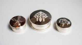 Three assorted early 20th century silver and tortoiseshell pique circular boxes and covers,