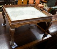 A rectangular oak tray top low table inset with a map of Sussex on ball and claw stand, width