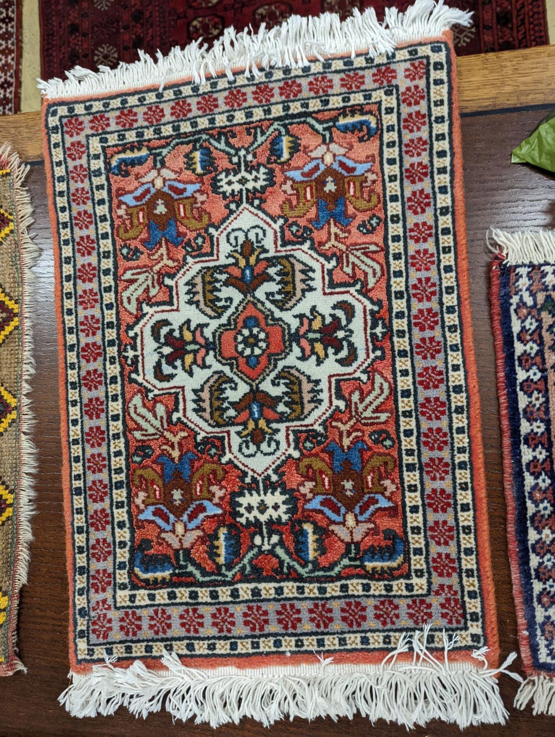 A Caucasian red ground mat, a Bokhara mat, three others and a blue ground rug, largest 136 x 80cm ( - Image 7 of 7