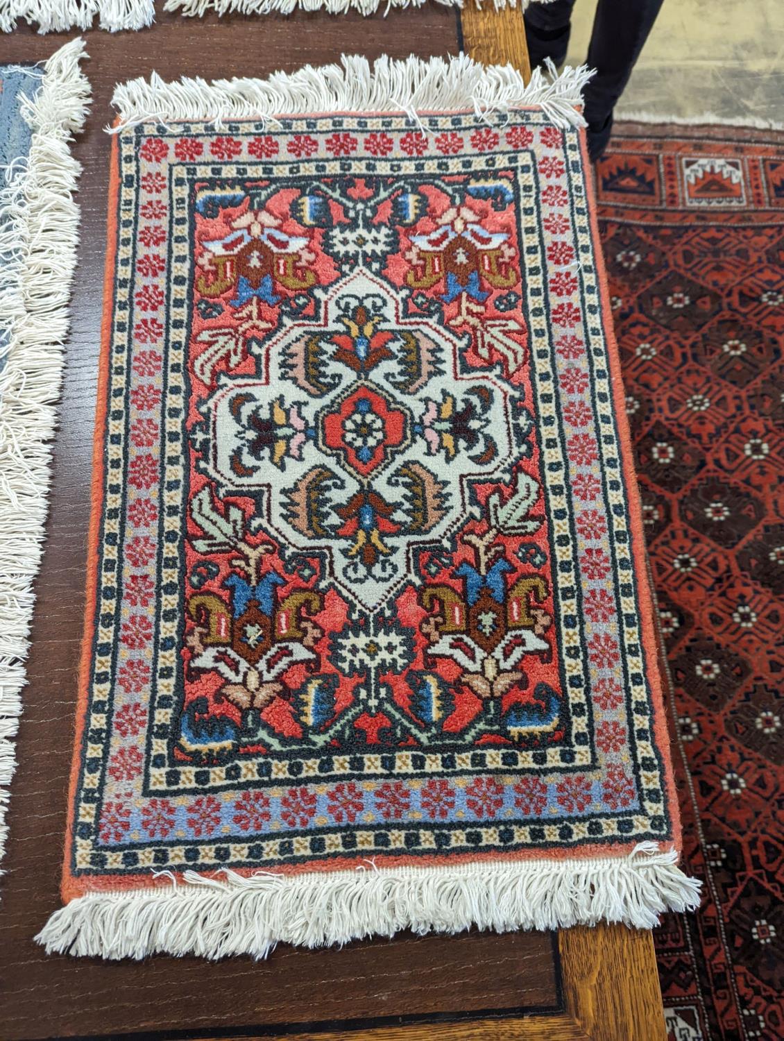 A Caucasian red ground mat, a Bokhara mat, three others and a blue ground rug, largest 136 x 80cm ( - Image 5 of 7