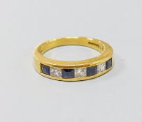A modern 18ct gold, four stone sapphire and three stone diamond set half hoop ring, size P, gross
