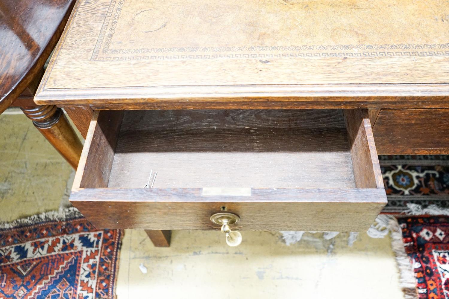 A 1920's oak two drawer writing table, with a leather inset top, length 106cm, depth 52cm, height - Image 3 of 4