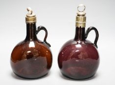 A Victorian amethyst glass claret and amber hock jugs, 23cm