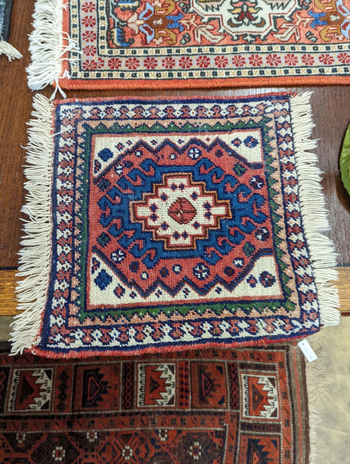 A Caucasian red ground mat, a Bokhara mat, three others and a blue ground rug, largest 136 x 80cm ( - Image 6 of 7