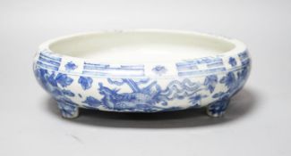 A 19th century Chinese circular blue and white censer, with phoenix and peony decoration, on three