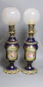 A matched pair of hand-painted Paris porcelain converted oil lamps 57cm