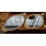 A pair of oval gilt framed wall mirrors inset porcelain plaques, width 42cm, height 78cm